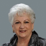 Portrait of a smiling elderly woman on a gray background